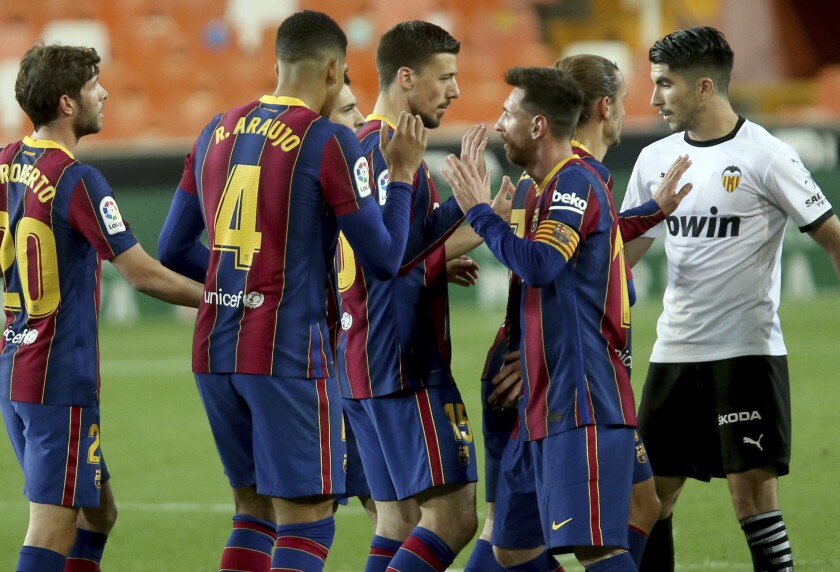 Barcelona's Lionel Messi celebrates with team mates the victory of his team at the end of a Spanish La Liga soccer match against Valencia at the Mestalla stadium in Valencia, Spain, Sunday, May 2, 2021. (AP Photo/Alberto Saiz)