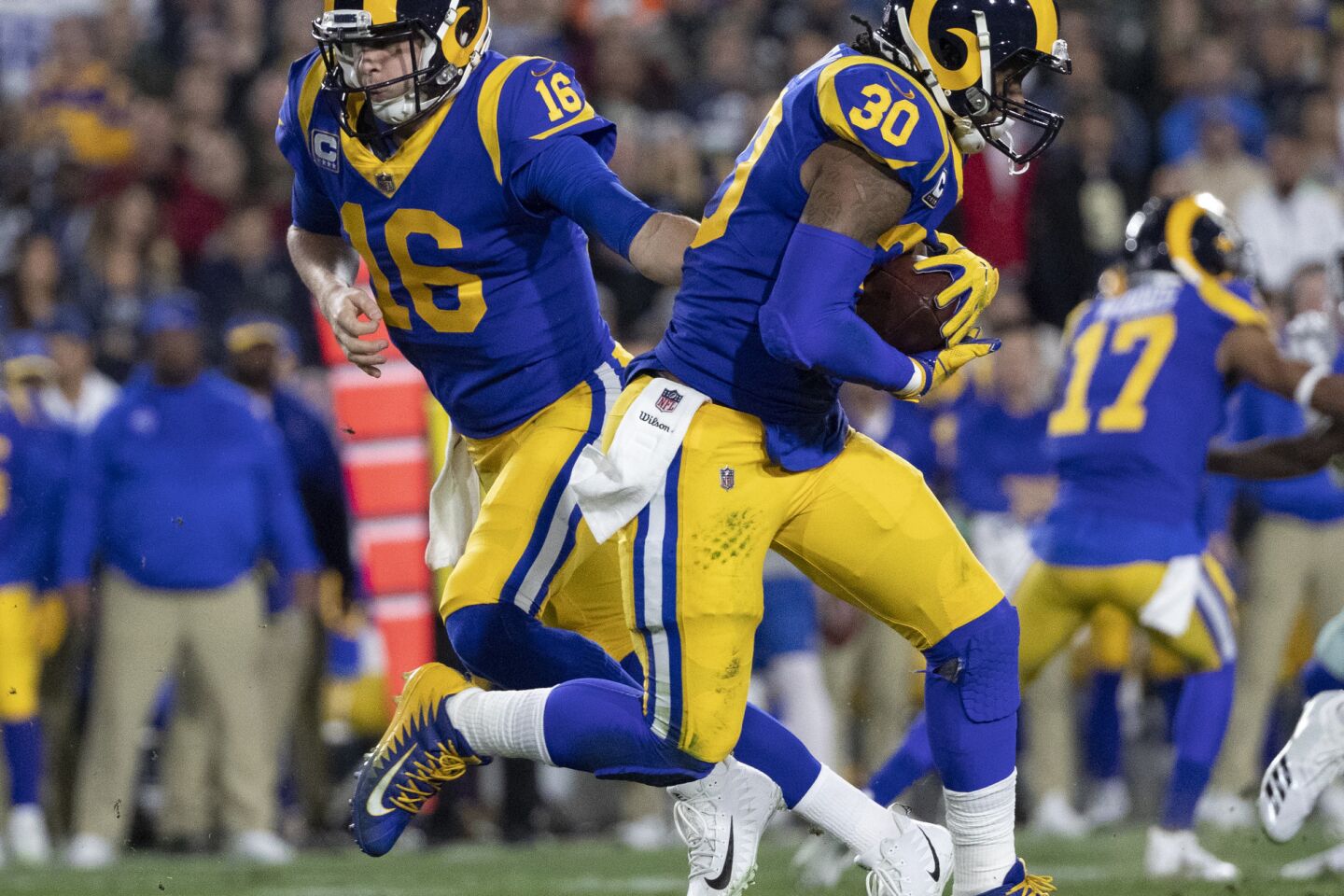 Rams quarterback Jared Goff (16) hands off to running back Todd Gurley (30) during the first half.