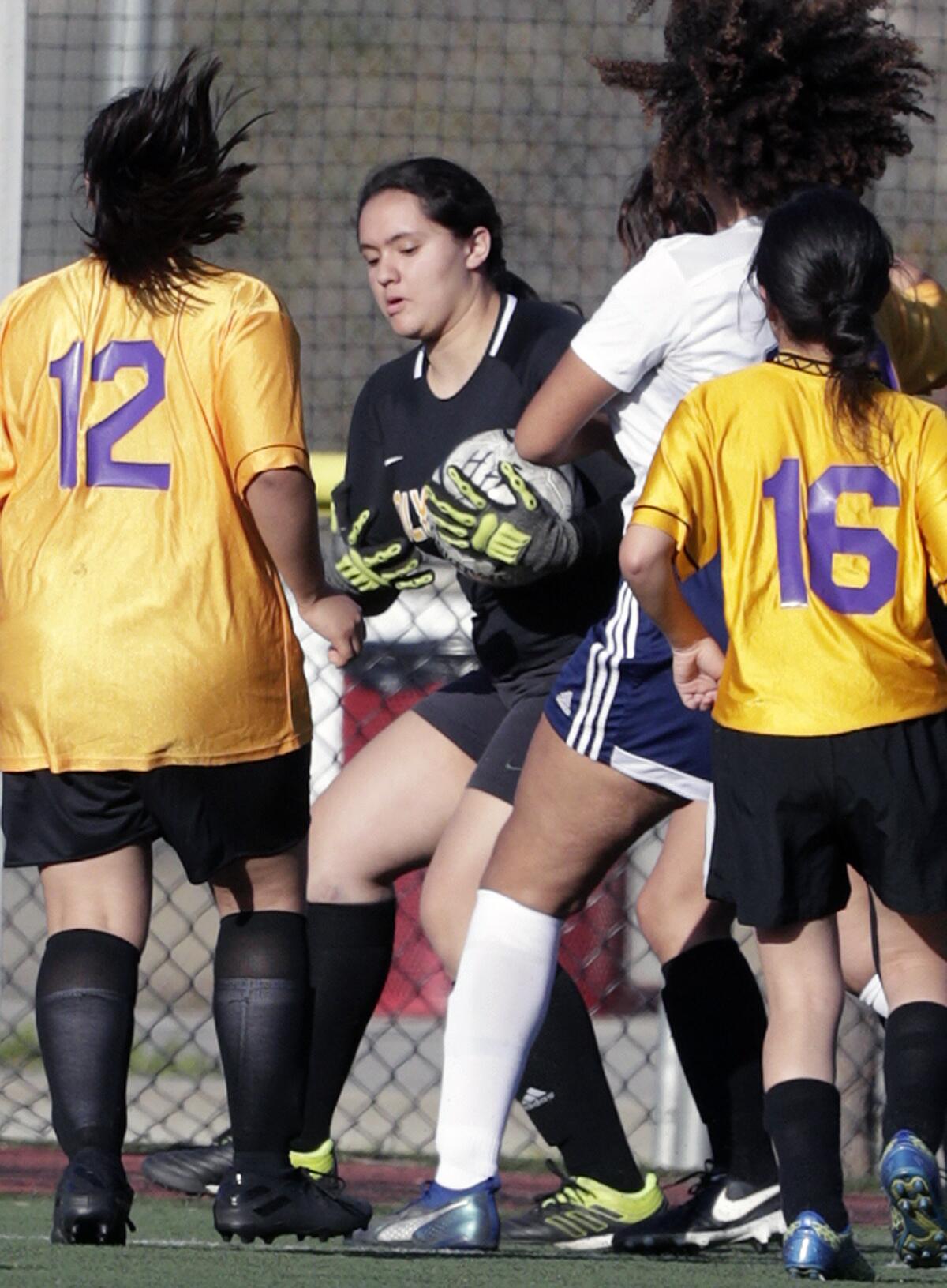 Holy Family's goalie Maely Lopez collects the ball off of an Alverno Heights shot in a Horizon League girls' soccer game at the Glendale Sports Complex in Glendale on Monday, January 27, 2020.