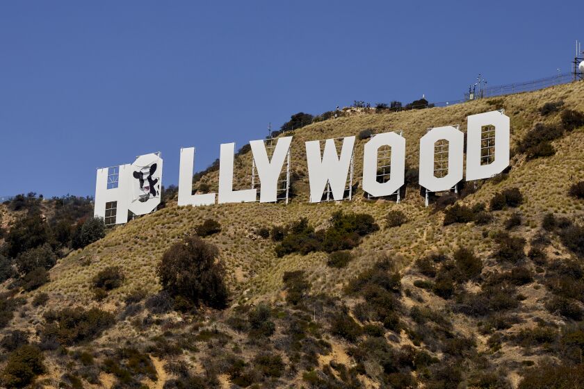 A photo showing the "Holy Cow" sign that was placed on the Hollywood Sign in Los Angeles. Credit: Adam Kargenian