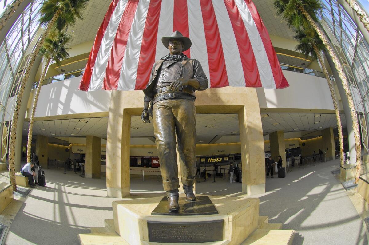 A 9-foot bronze statue of legendary late actor and Newport Beach resident John Wayne is a landmark at Orange County's John Wayne Airport.