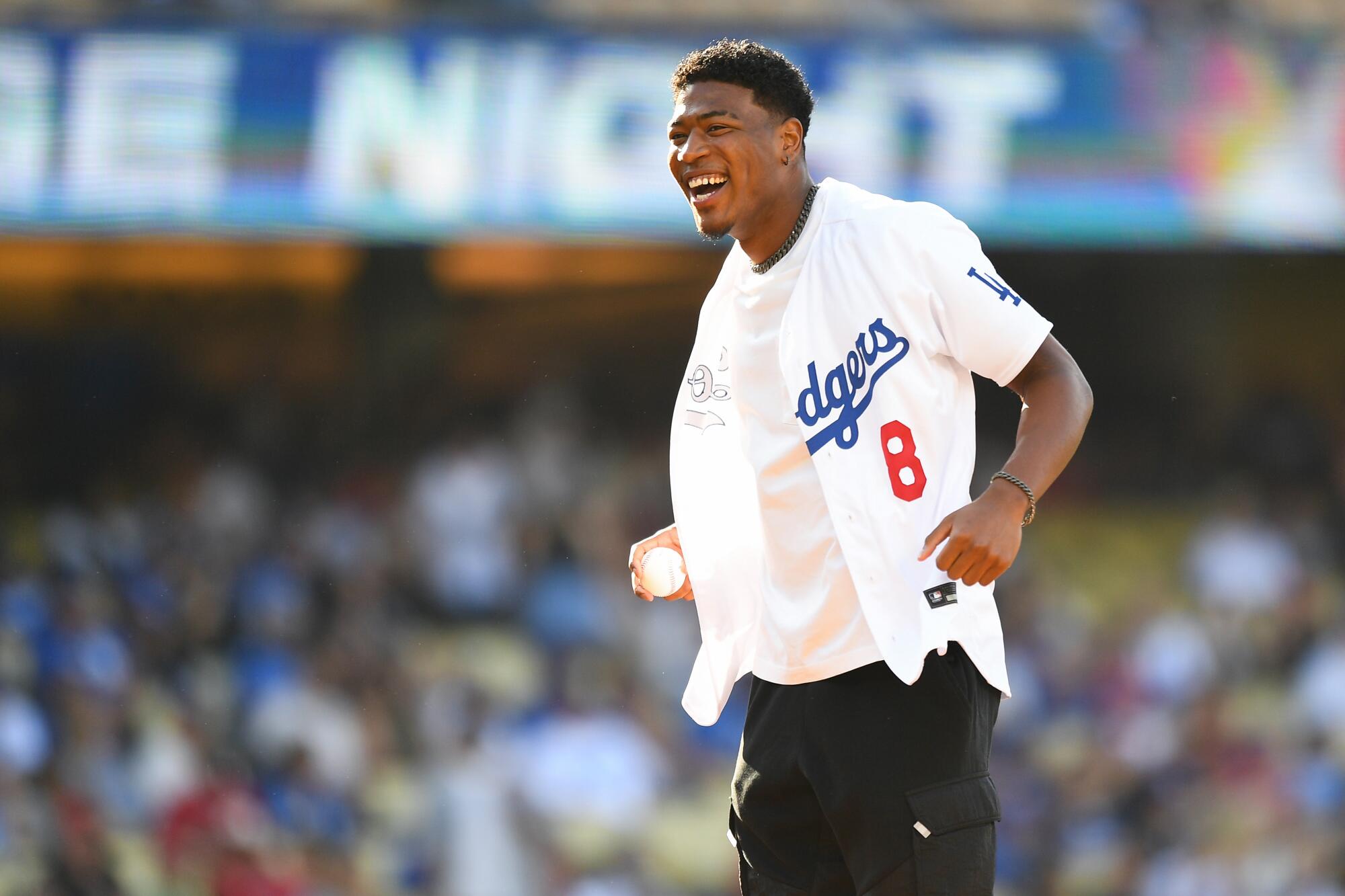 Lakers forward Rui Hachimura gets ready to throw out the first pitch before a Dodgers-Angels game in July at Dodger Stadium.