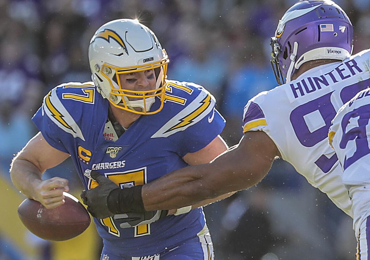 Minnesota Vikings defensive end Danielle Hunter (99) strips the ball from Chargers quarterback Philip Rivers.