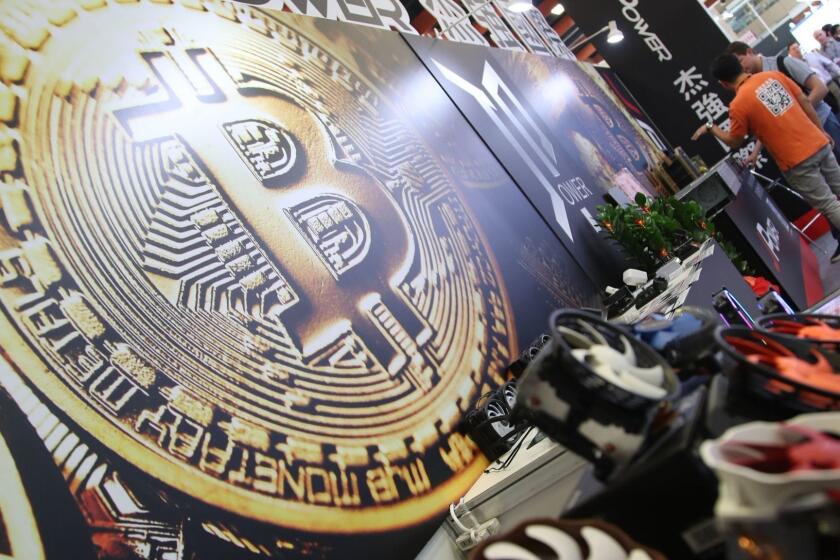 Mandatory Credit: Photo by RITCHIE B. TONGO/EPA-EFE/REX/Shutterstock (9703431e) A bitcoin logo is seen next to computer fans during the Computex 2018 in Taipei, Taiwan, 05 June 2018. The Computex 2018 event will run from 05 June to 09 June 2018 and will exhibit innovations from various computer designers. Computex 2018 expo begins in Taiwan, Taipei - 05 Jun 2018 ** Usable by LA, CT and MoD ONLY **