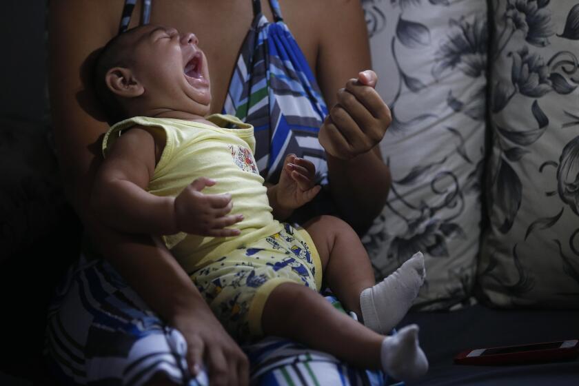 Janine Santos holds her 3-month-old son, who was born with microcephaly in Joao Pessoa, Brazil. U.S. and Brazilian health workers are enrolling mothers in a study aimed at determining whether the Zika virus really is causing a surge in birth defects.