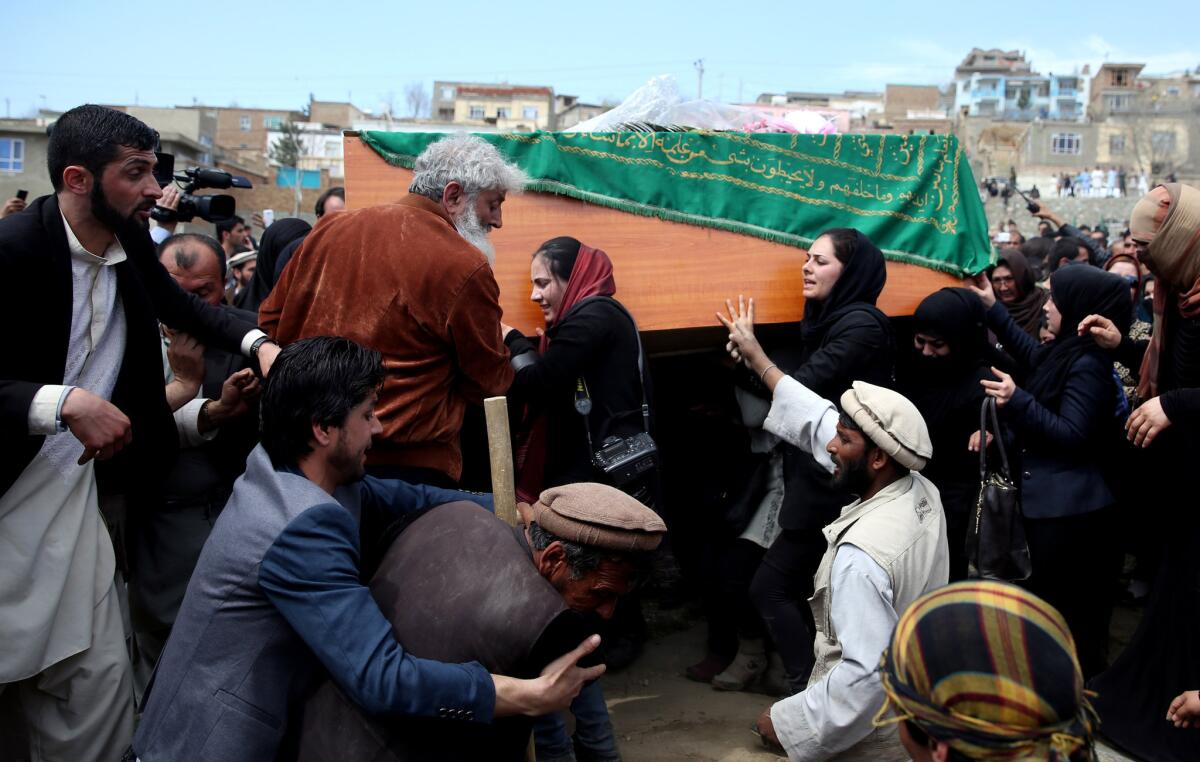 Women's rights activists carry the coffin of a woman identified only as Farkhunda, who was killed by a mob, during her funeral in Kabul, Afghanistan, on March 22.