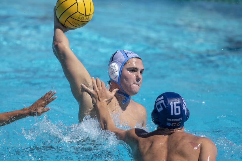 Corona del Mar's Tanner Pulice takes a shot under pressure from Valley Christian's Christina Wise during a pool-play game in the California State High School Championships at Yorba Linda High School on Friday, July 12.