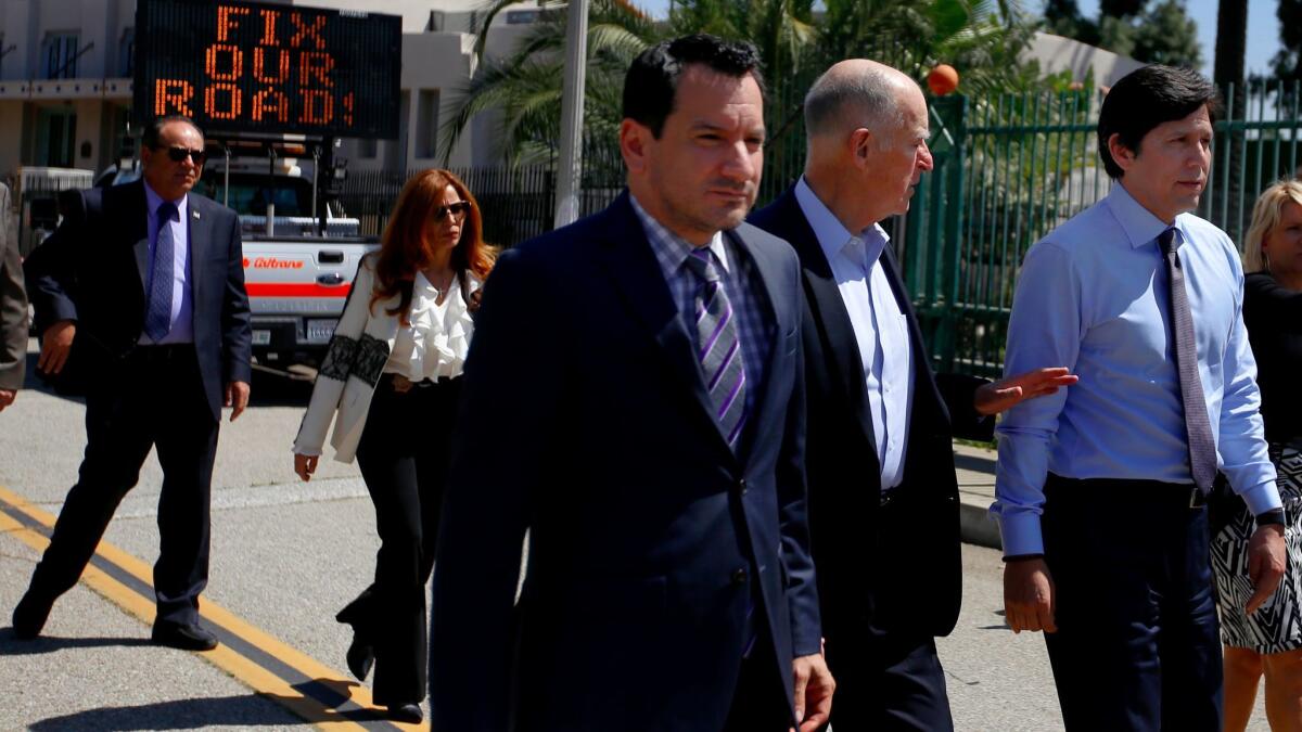 Assembly Speaker Anthony Rendon, from left, Gov. Jerry Brown and Senate President Pro Tem Kevin de León walk toward a news conference in Riverside on April 4, 2017.