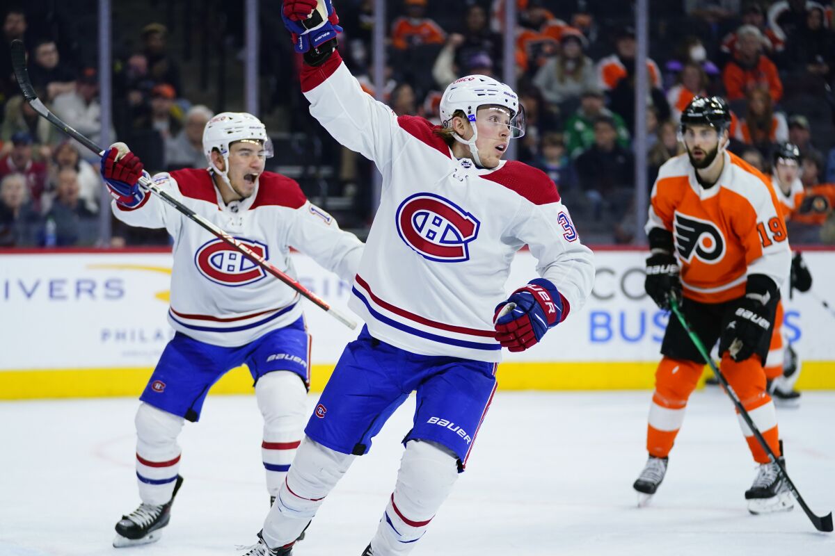 Montreal Canadiens' Rem Pitlick, center, celebrates after scoring a goal during the third period of an NHL hockey game against the Philadelphia Flyers, Sunday, March 13, 2022, in Philadelphia. (AP Photo/Matt Slocum)
