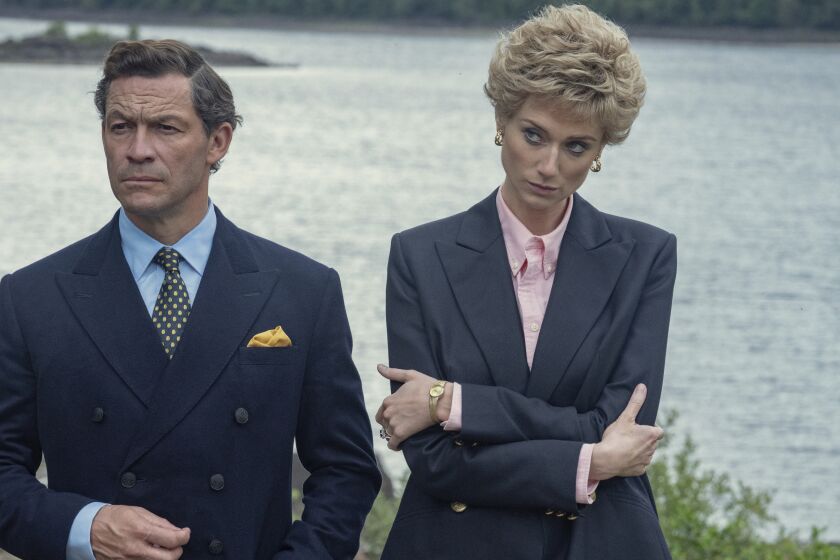 This image released by Netflix shows Dominic West as Prince Charles, left, and Elizabeth Debicki as Princess Diana in a scene from 'The Crown." (Keith Bernstein/Netflix via AP_