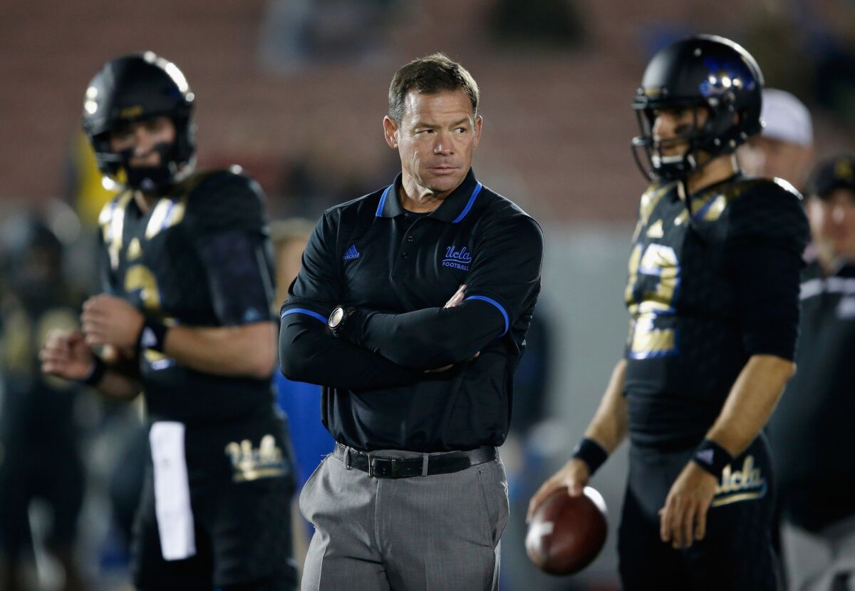 UCLA Coach Jim Mora stands with his team prior to a game against Washington State Cougars.