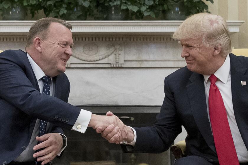 President Donald Trump and Danish Prime Minister Lars Lokke Rasmussen shake hands in the Oval Office at the White House in Washington, Thursday, March 30, 2017.
