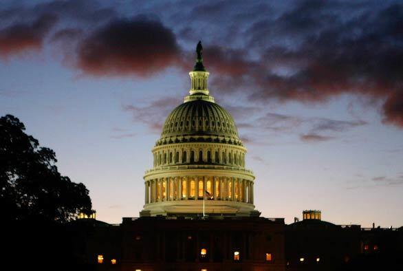 The sun begins to rise behind the U.S. Capitol building, where the House was set for a vote on the proposed Wall Street bailout legislation.