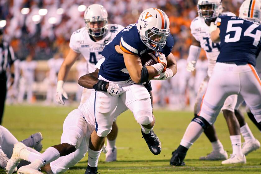 CHARLOTTESVILLE, VA - SEPTEMBER 21: Wayne Taulapapa #21 of the Virginia Cavaliers rushes for a touchdown in the second half during a game against the Old Dominion Monarchs at Scott Stadium on September 21, 2019 in Charlottesville, Virginia. (Photo by Ryan M. Kelly/Getty Images) ** OUTS - ELSENT, FPG, CM - OUTS * NM, PH, VA if sourced by CT, LA or MoD **