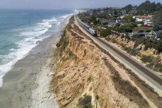 A Surfliner train by Amtrak travels along the collapsing bluffs in Del Mar in 2019.