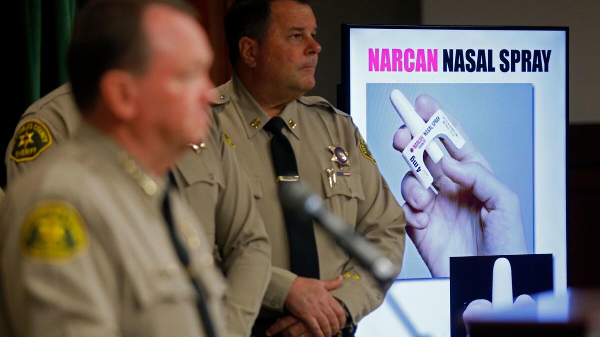 At a news conference, Los Angeles County Sheriff Jim McDonnell, foreground, announces the deployment of the anti-opioid nasal spray product Narcan to field deputies.