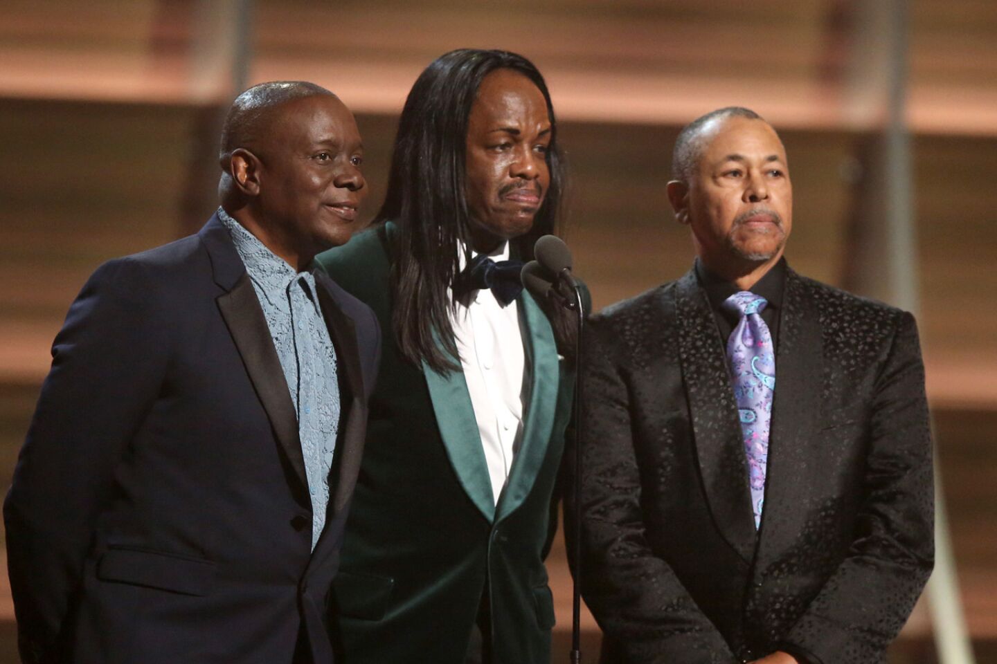 Philip Bailey, from left, Verdine White and Ralph Johnson of Earth Wind & Fire present the award for album of the year.