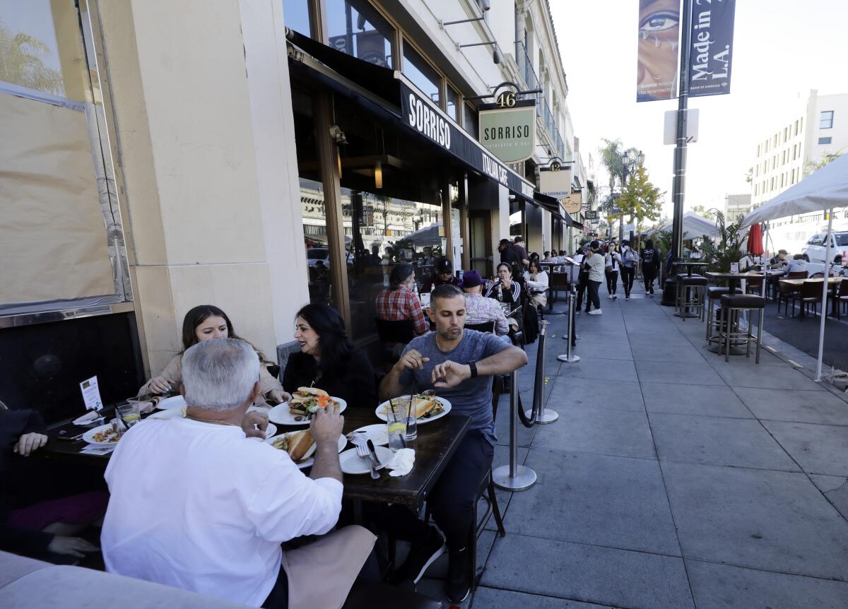 Visitors to Old Pasadena dine outdoors along Colorado Boulevard on Sunday, Nov. 29.