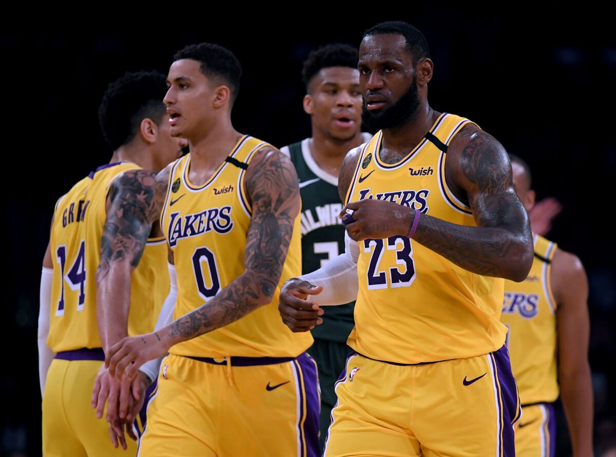 The Lakers' LeBron James (23) and Kyle Kuzma (0) react after a James score at Staples Center on March 6.
