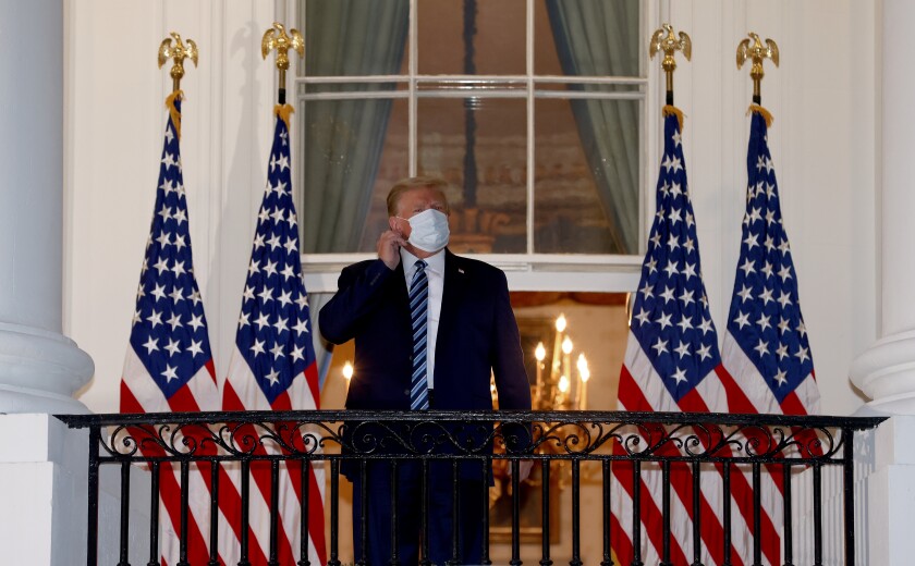 Trump takes off his mask.
