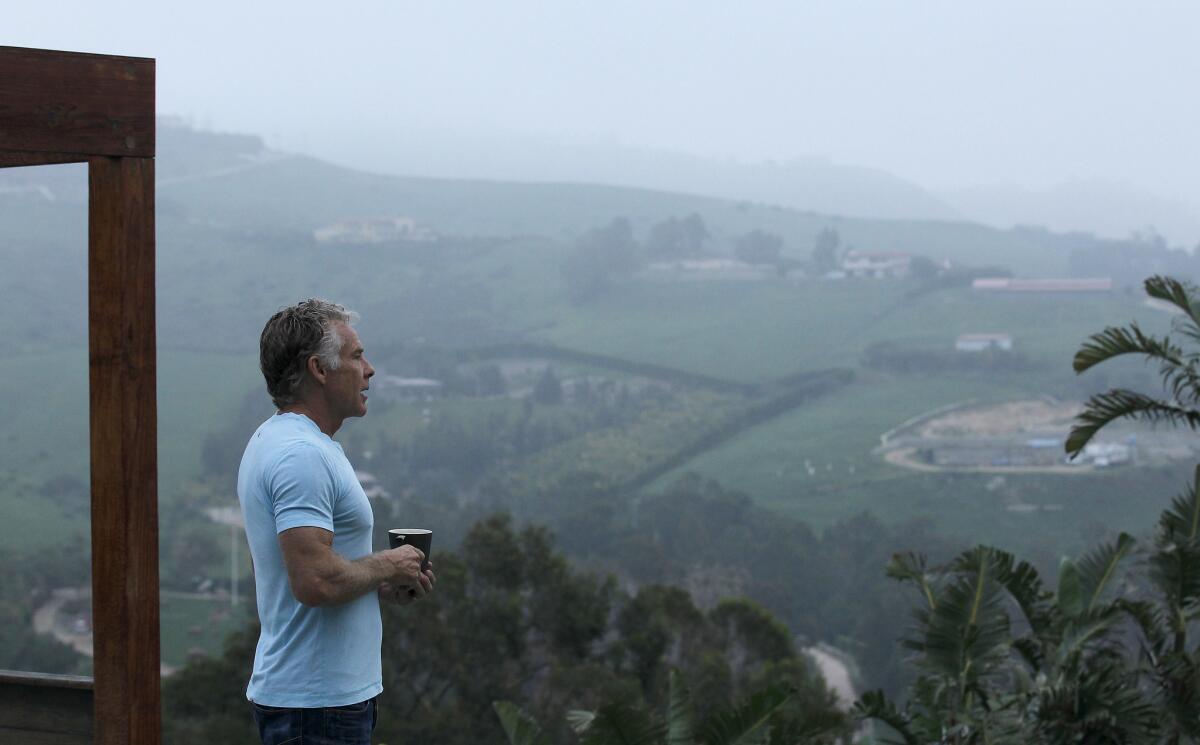 Mark Sisson, creator of the Primal Living Diet, stands for a meditative moment in the yard of his hillside home in Malibu.