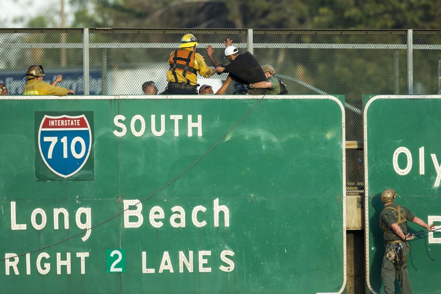 Man hangs from sign above 5 Freeway