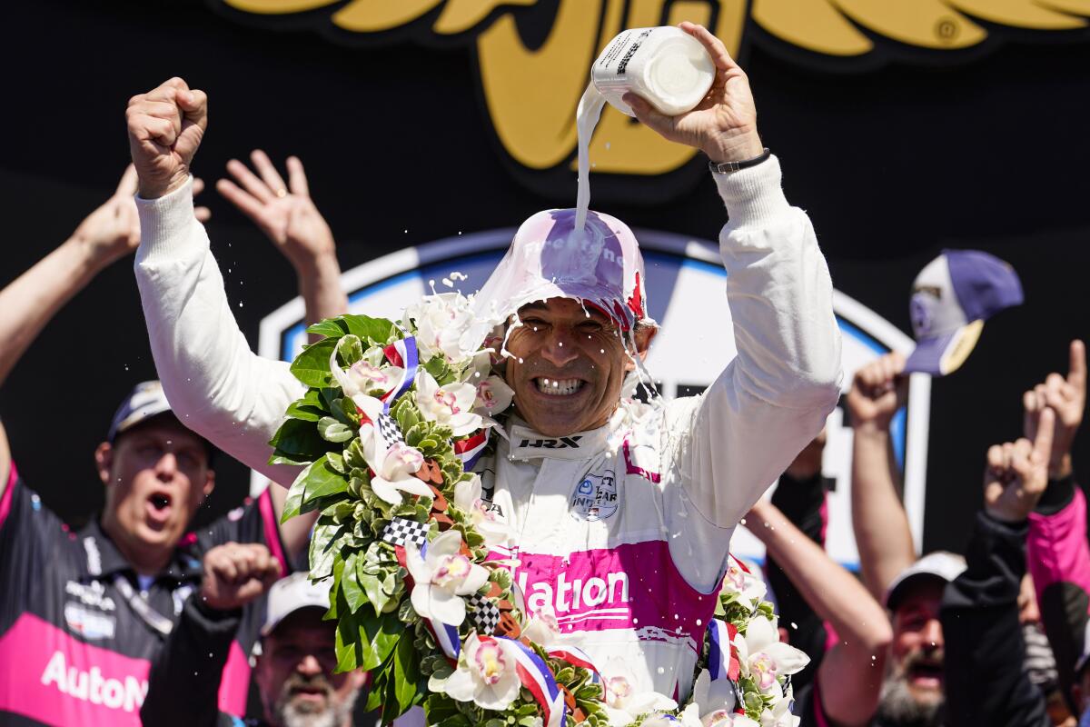Helio Castroneves pours milk on his head after winning the Indianapolis 500 for the fourth time on Sunday.