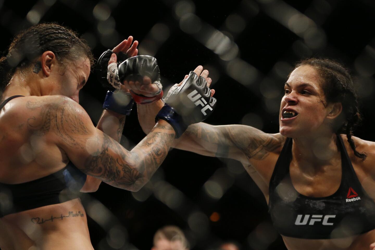 Amanda Nunes, right, from Brazil, fights Raquel Pennington, from the United States, during their UFC women's bantamweight mixed martial arts bout in Rio de Janeiro, Brazil, early Sunday, May 13, 2018. (AP Photo/Leo Correa)