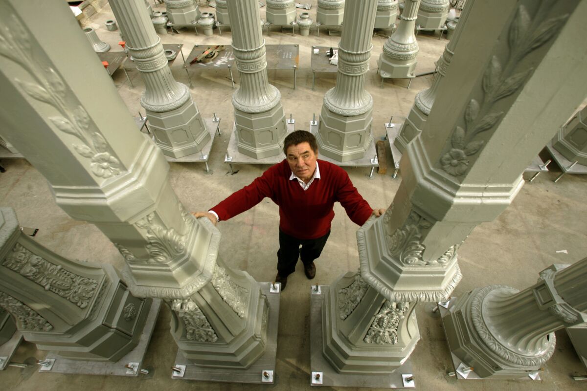 Chris Burden stands amid "Urban Light," his installation at the Los Angeles County Museum of Art.