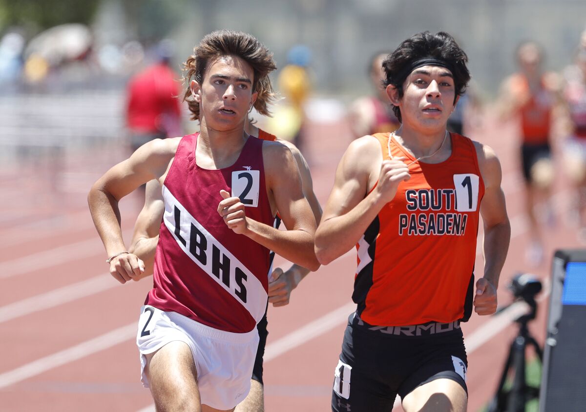 Mateo Bianchi of Laguna Beach, left, races elbow-to-elbow with South Pasadena's Andrew Villapudua in the 1,600-meter run.