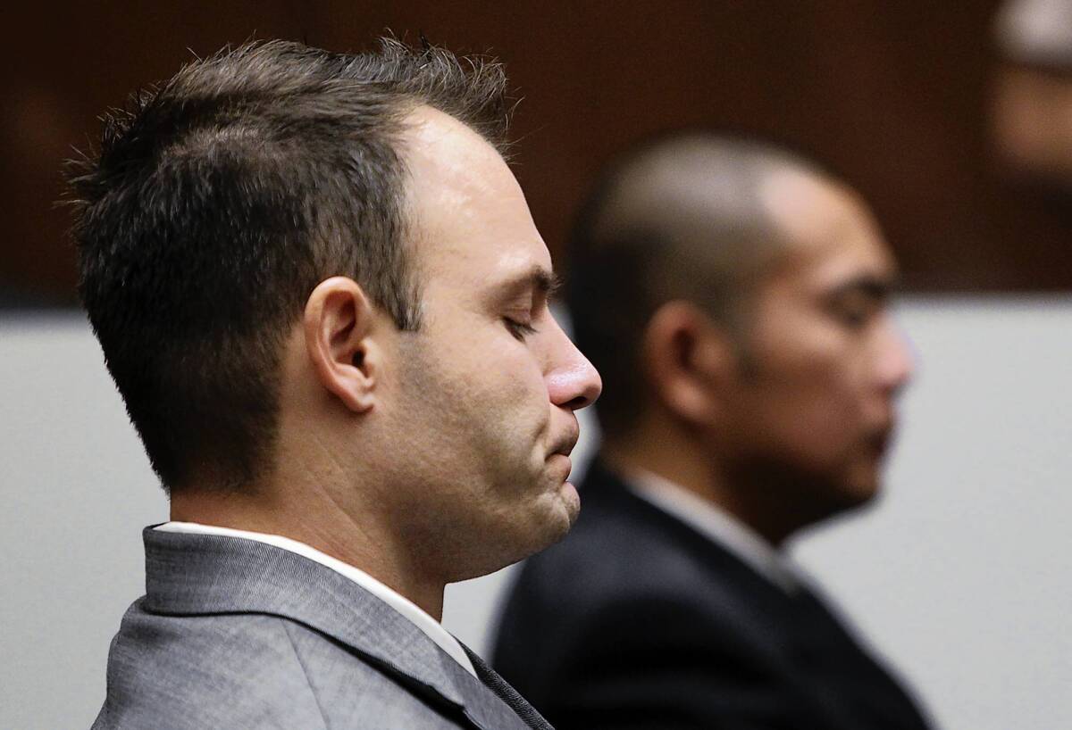 Former LAPD Officer Evan Samuel, left, reacts after the jury found him and Officer Richard Amio, right, guilty of perjury and conspiracy to obstruct justice.