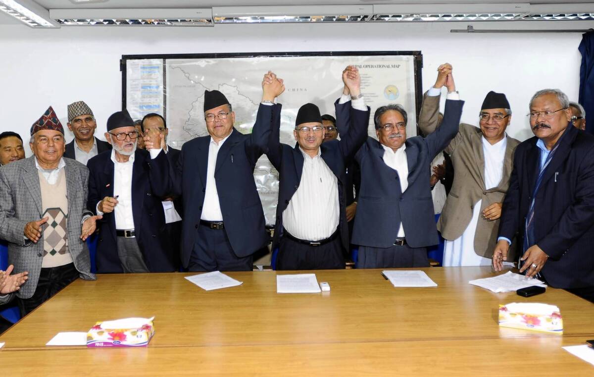Nepalese Prime Minister Baburam Bhattarai , center right, and leaders of political parties celebrate after signing an agrement in Kathmandu, the capital. The prime minister is to step down, with the Supreme Court chief justice taking his place until an election is held.