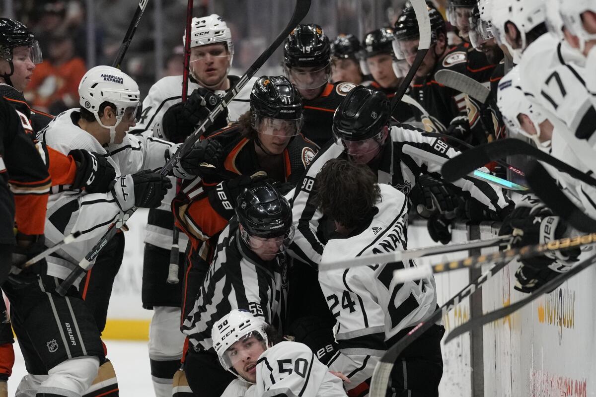 Kings and Ducks players scuffle near the Ducks' bench during the third period Thursday.