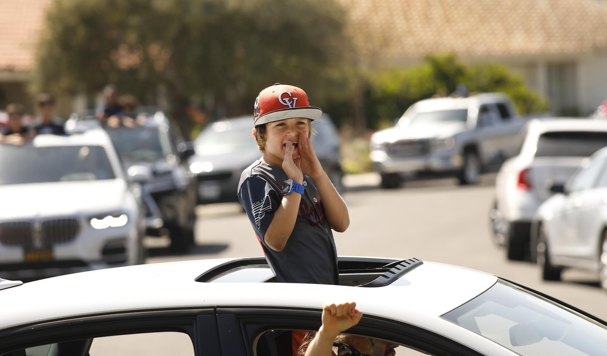 Kason Speer cheers on Peyton through a sunroof to mark his teammate's 8th birthday.