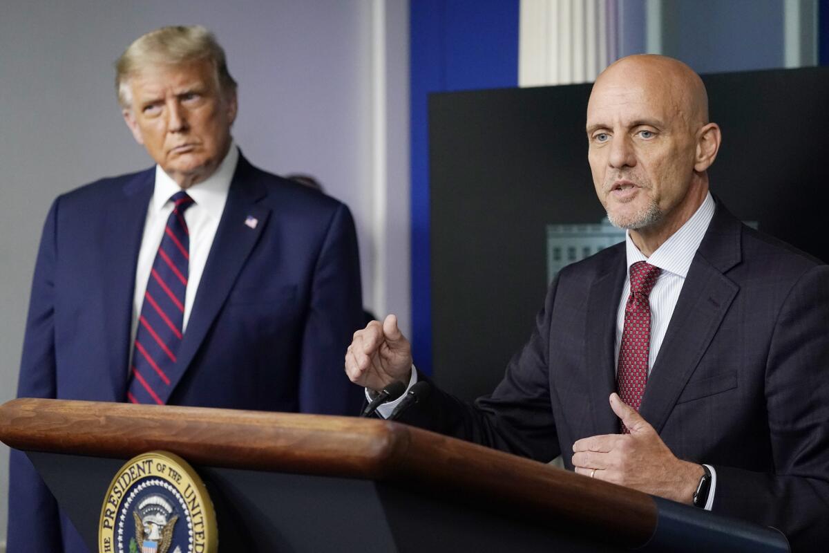 President Trump listens to Dr. Stephen Hahn, commissioner of the U.S. Food and Drug Administration