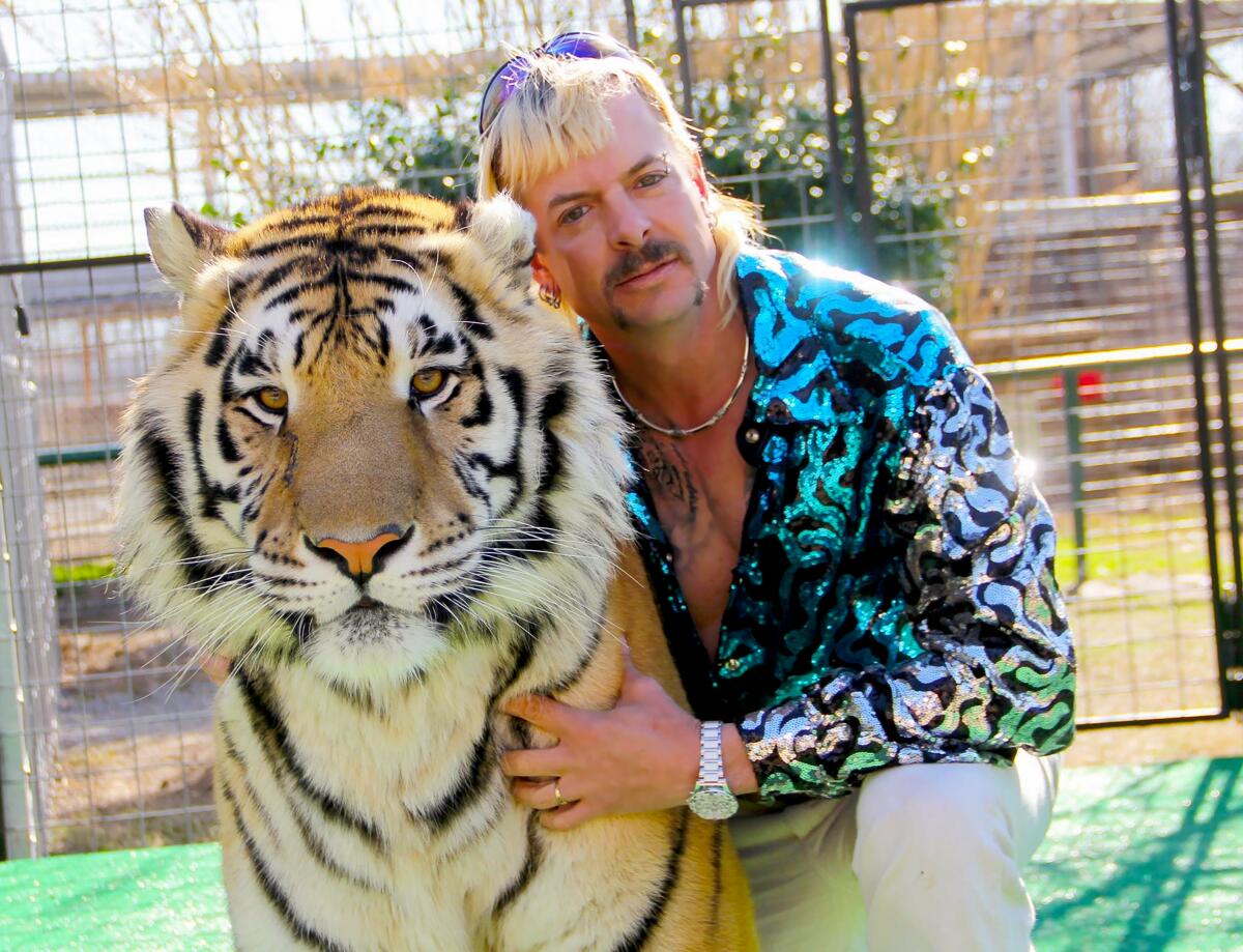 Joe Exotic poses with one of his wild cats in "Tiger King."