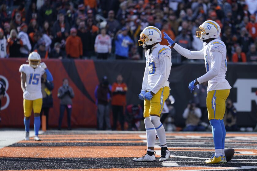 Los Angeles Chargers' Keenan Allen (13) reacts after making a touchdown reception during the first half of an NFL football game against the Cincinnati Bengals, Sunday, Dec. 5, 2021, in Cincinnati. (AP Photo/Michael Conroy)