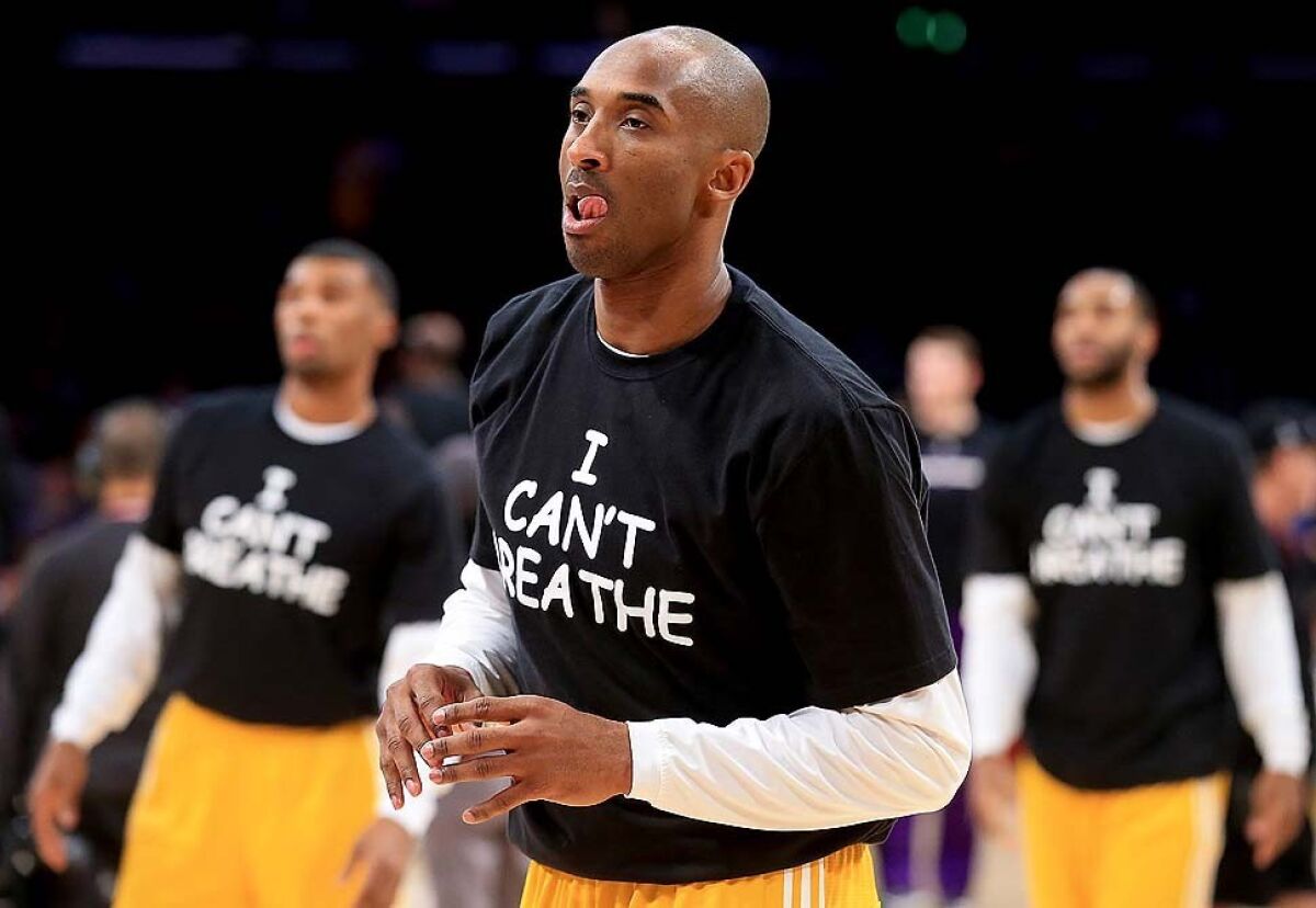 Kobe Bryant warms up before a game against the Kings while wearing a T-shirt saying "I can't breathe" in reference to the death of Eric Garner in New York, who died after police put him in a chokehold while he was being arrested for selling loose cigarettes.