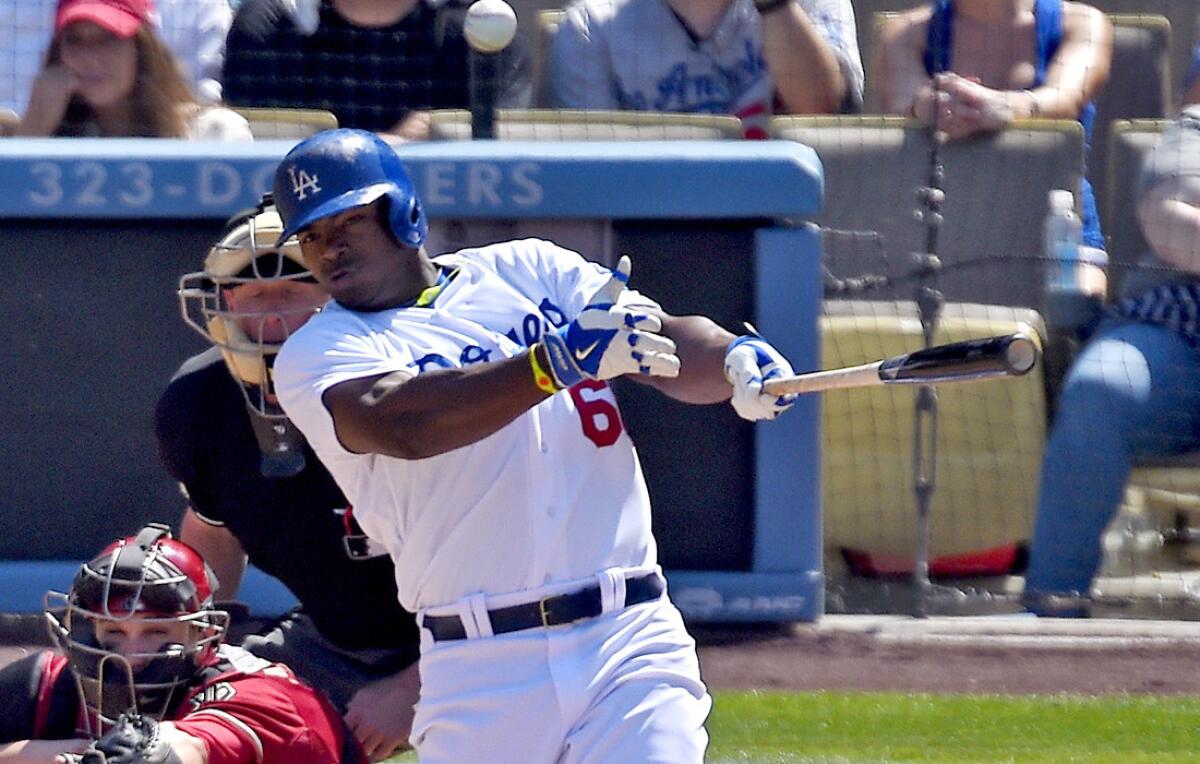 Dodgers right fielder Yasiel Puig connects for a three-run home run against the Arizona Diamondbacks in the sixth inning Sunday at Dodger Stadium.