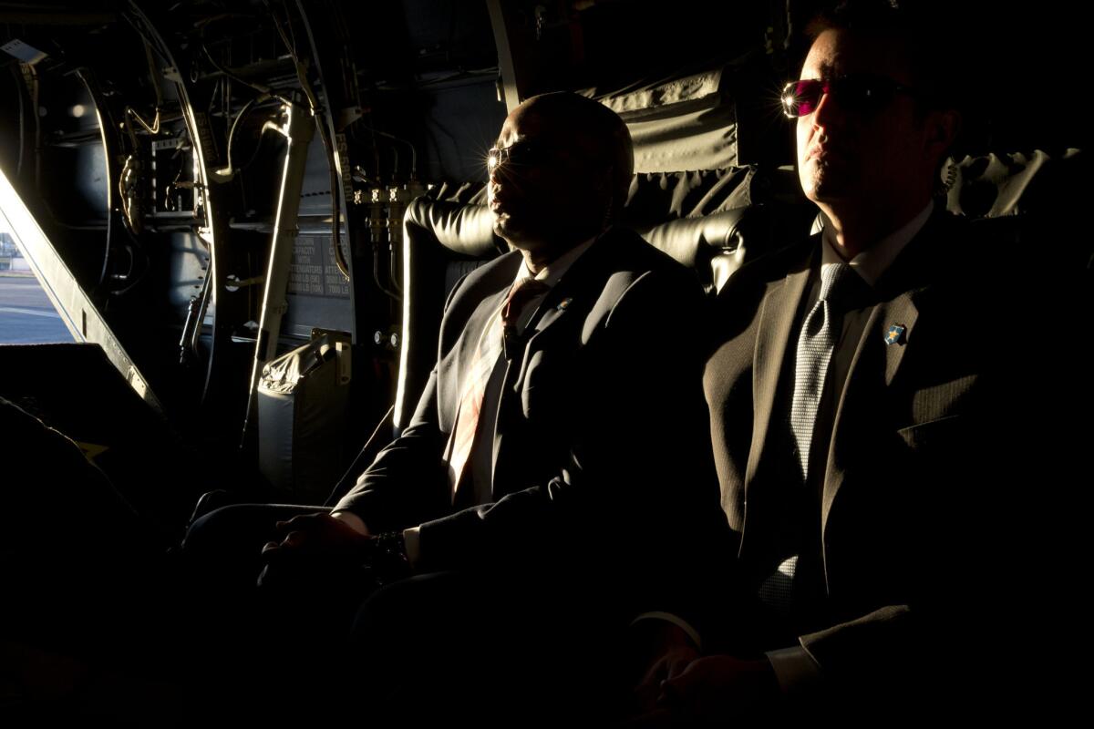 Secret Service agents ride in an Osprey aircraft on a trip by President Obama to Alabama on Saturday.