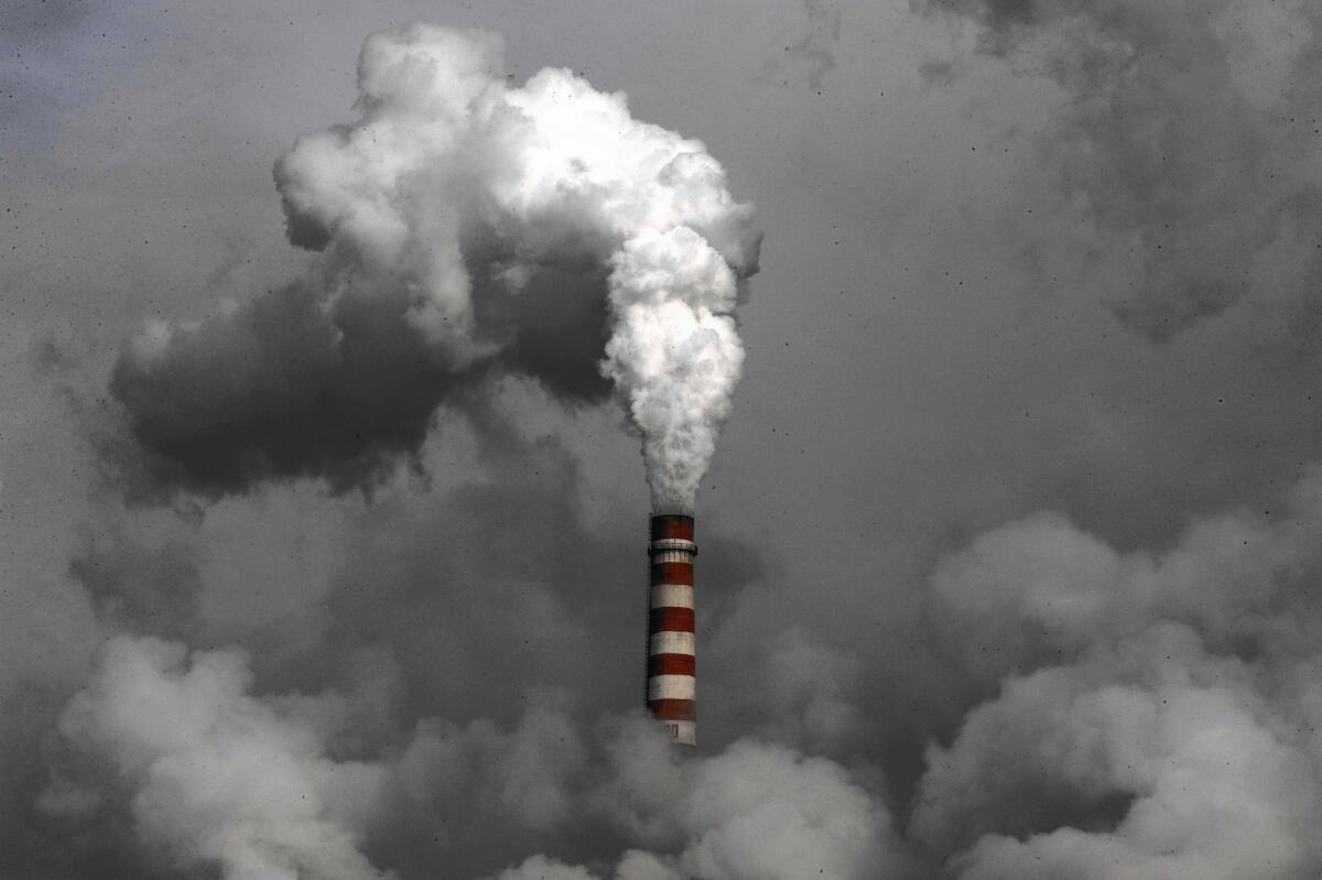 Under new promises, the cities of Beijing and Guangzhou are committing to start tapering their carbon dioxide emissions by the end of 2020. Above, smoke rises from a coal-fired Chinese power plant in 2009.