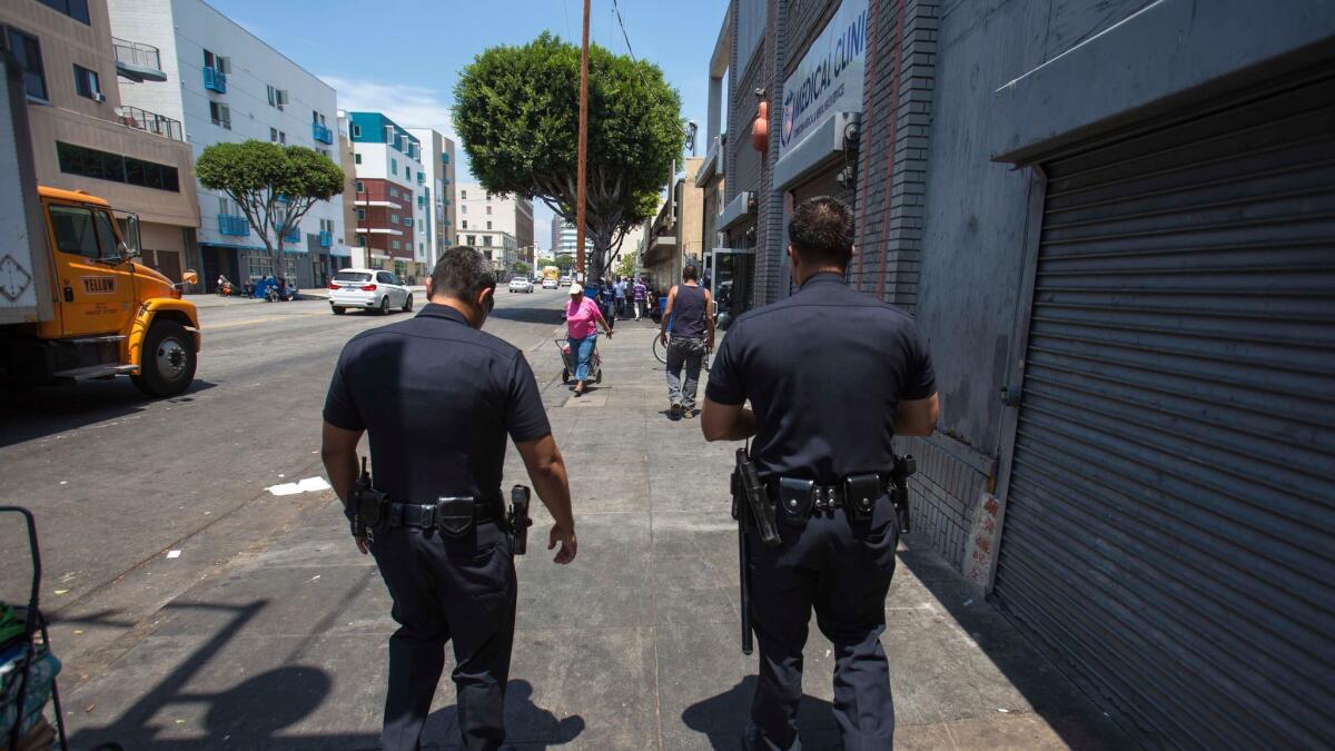LAPD officers patrol skid row downtown.