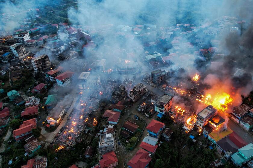 This aerial photo taken on October 29, 2021 show smokes and fires from Thantlang, in Chin State, where more than 160 buildings have been destroyed caused by shelling from Junta military troops, according to local media. (Photo by AFP) (Photo by STR/AFP via Getty Images)