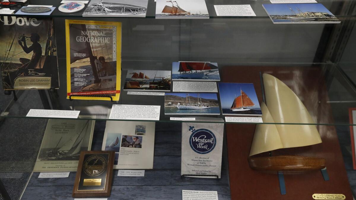 Photographs, articles and a wooden model sailboat are part of a display in “Costa Mesa: The Hull Story,” a new Costa Mesa Historical Society exhibit about the city’s boatbuilding history.