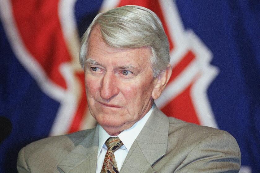 FILE - In this Aug. 6, 1996, file photo, John McNamara listens to questions during a news conference in Anaheim, Calif.,, announcing his assumption of managerial duties of the California Angels. McNamara, who managed several Major League Baseball teams during his career, died Tuesday, July 28, 2020, in Tennessee. He was 88. (AP Photo/Tammy Lechner, File)