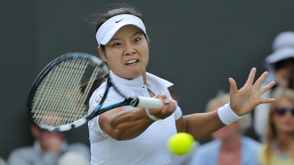 Li Na returns a shot during her second-round victory over Yvonne Meusburger at Wimbledon on Wednesday.
