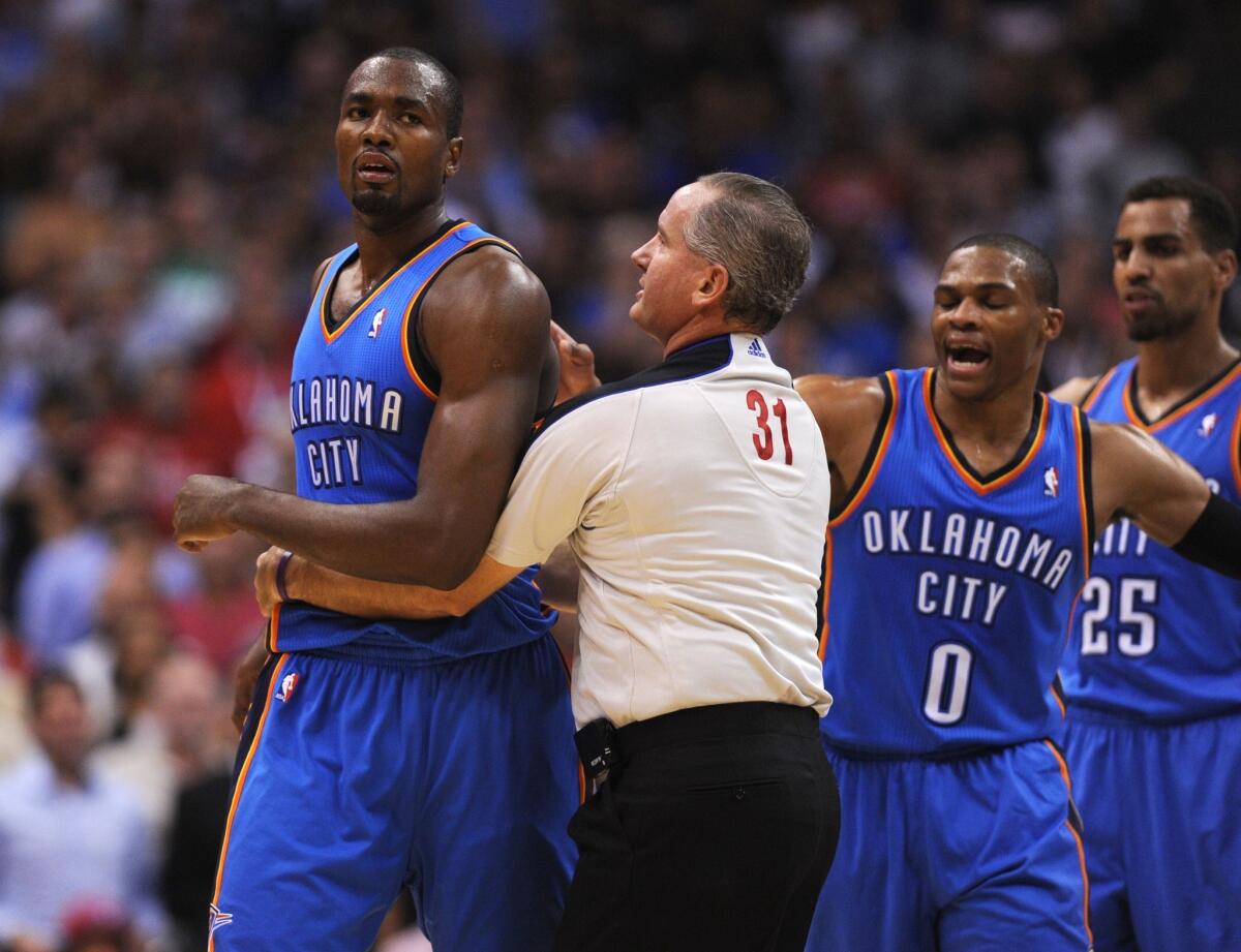 Oklahoma City's Serge Ibaka, left, is restrained by a referee after getting into a dispute with Clippers forward Matt Barnes.