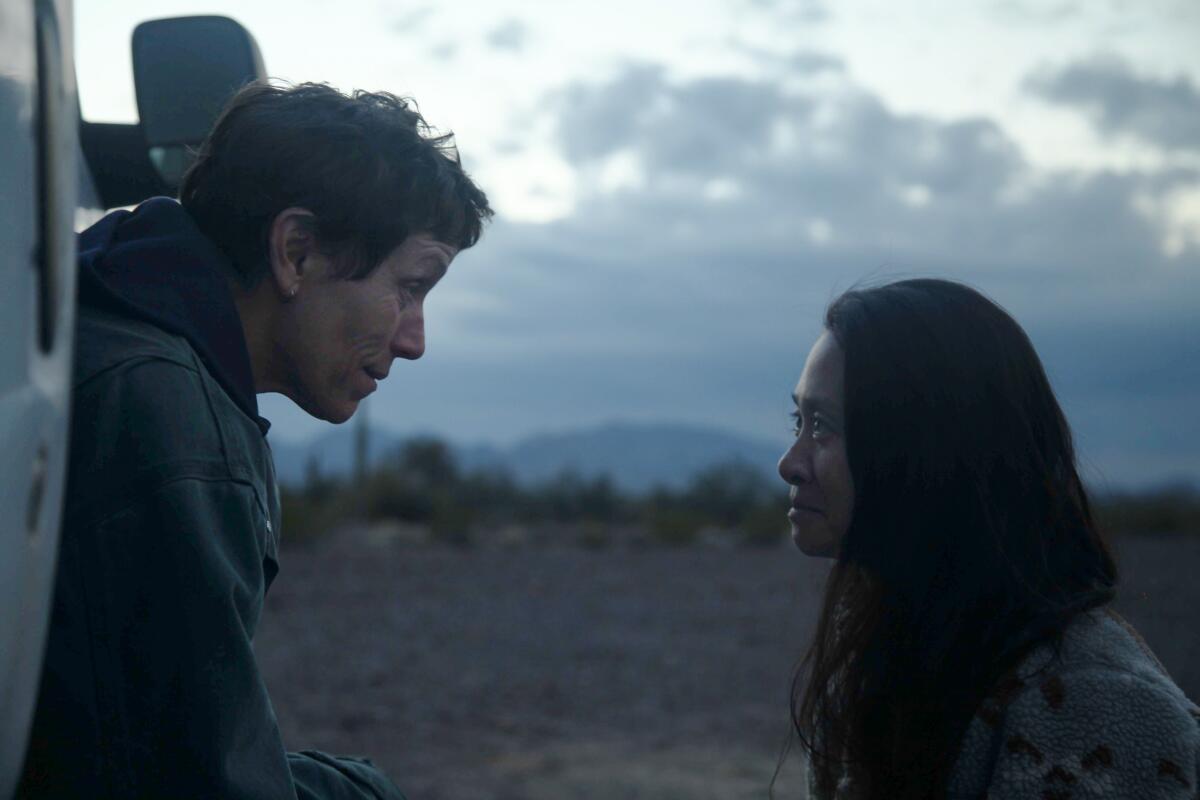 Frances McDormand and Chloé Zhao, outdoors during filming.  