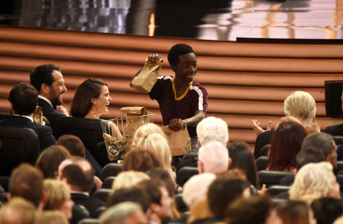 Caleb McLaughlin distributes sandwiches at the Emmy Awards.