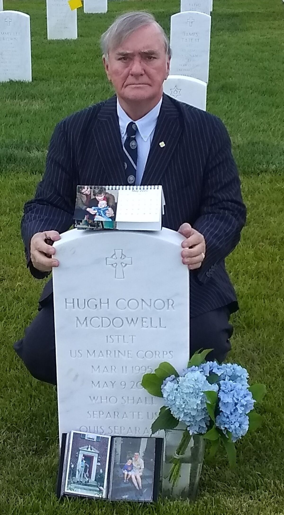 Michael McDowell at the grave of his son, 1st. Lt. Conor McDowell, at Arlington National Cemetery in Arlington, Va.